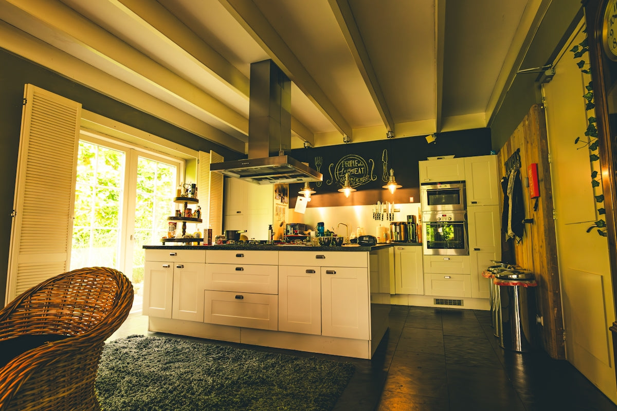 Spacious kitchen with island and stainless steel appliances.