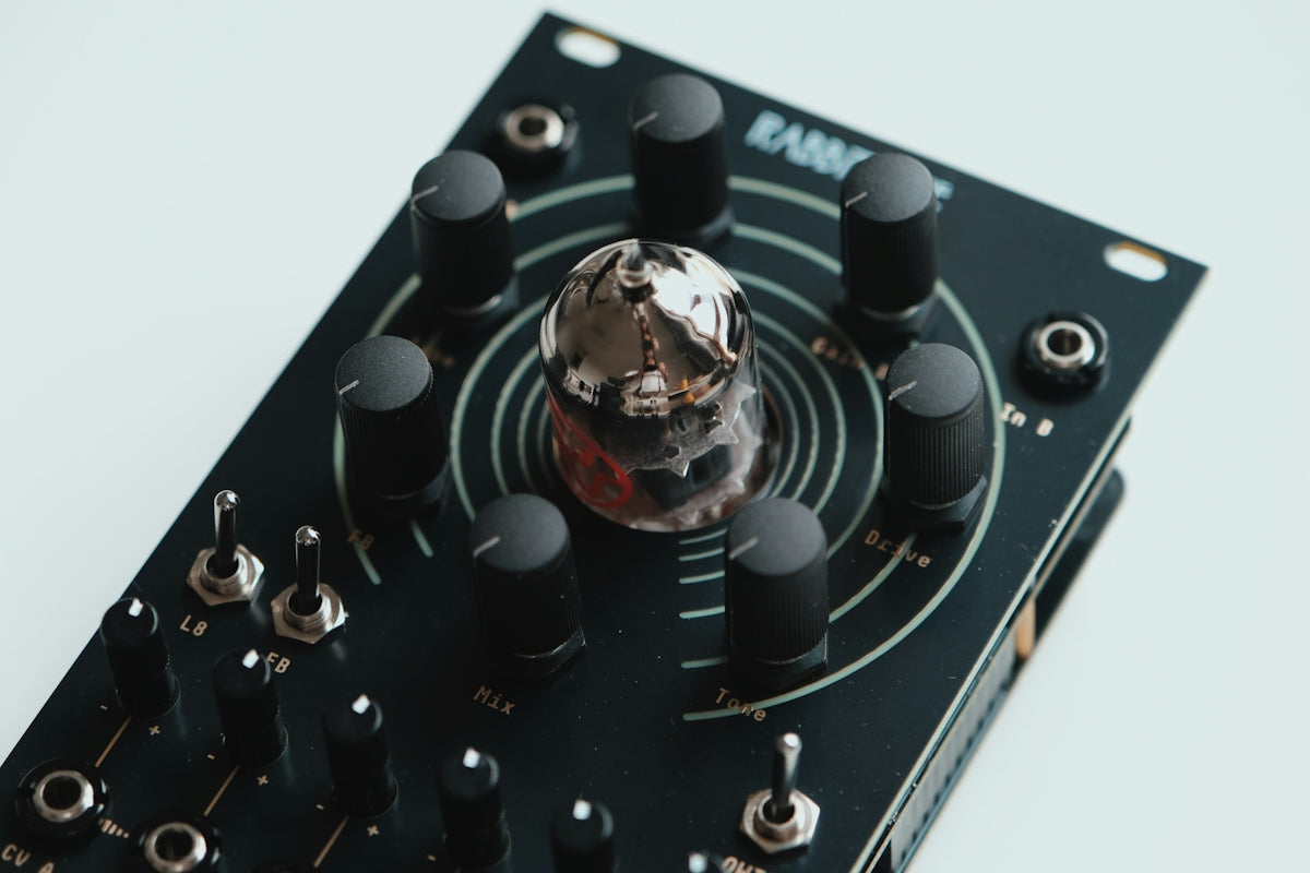 Close-up of a black electronic device with knobs and switches