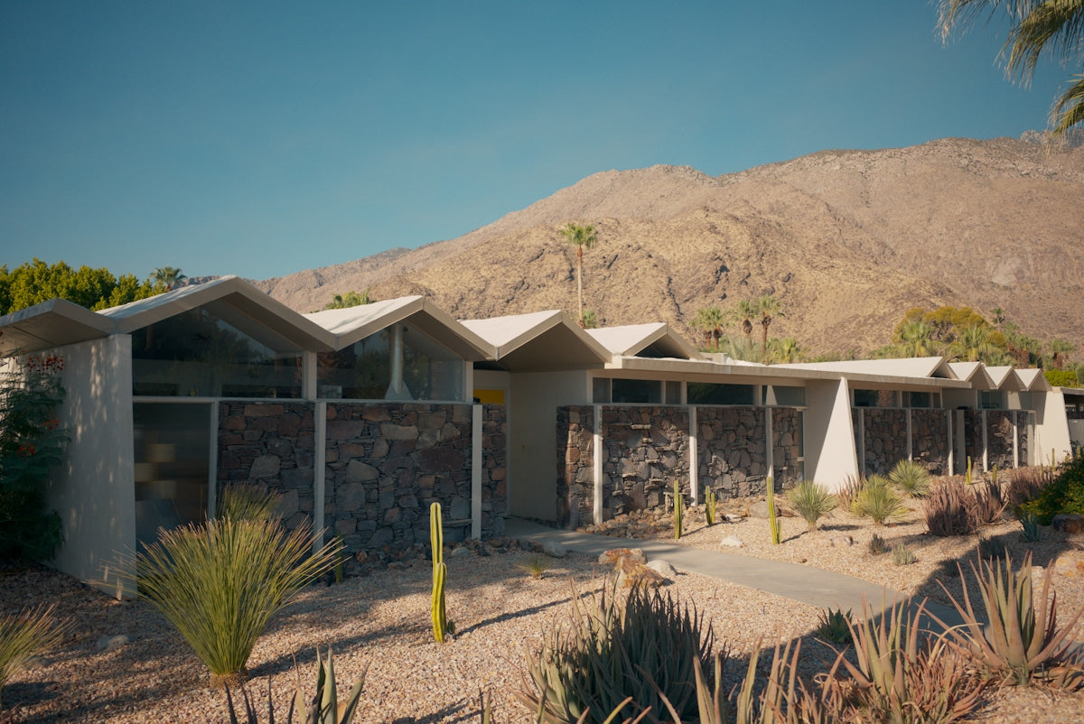 Mid-century modern house with desert plants and mountains