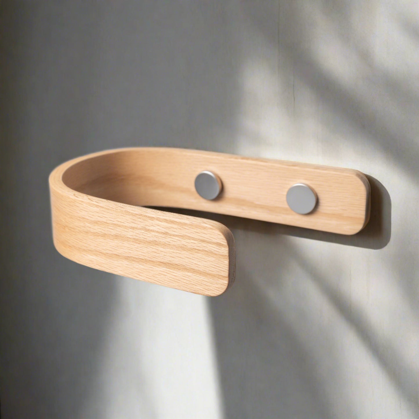 Oak curtain holdback placed on the wall with chrome fittings
