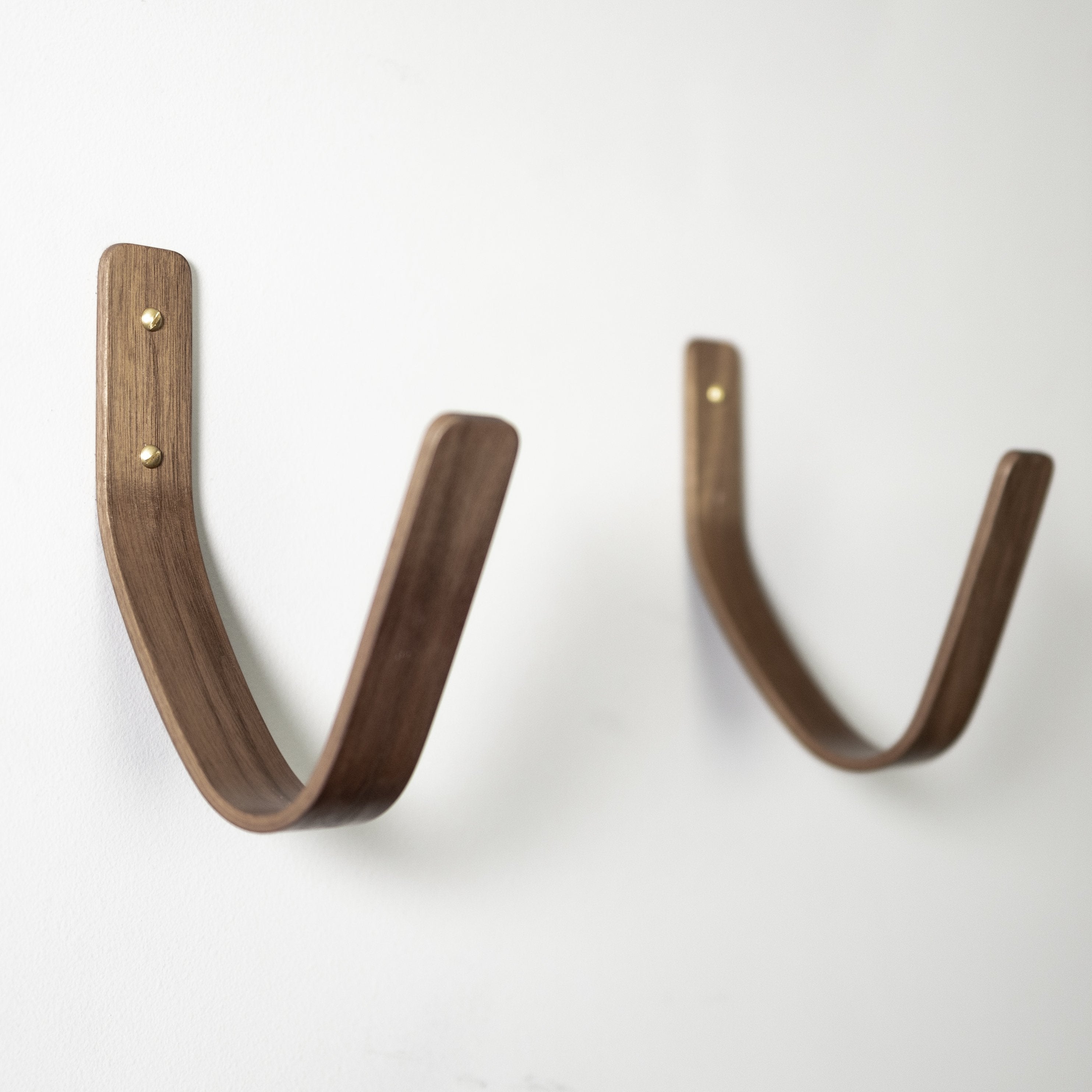 Walnut surfboard wall mount displaying surfboard horizontally