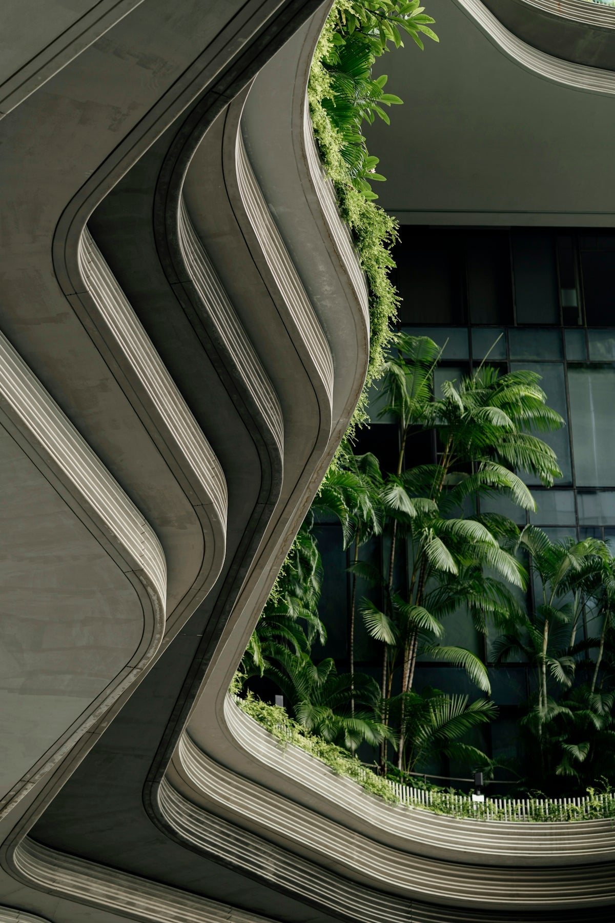 Modern building with organic curves and lush greenery