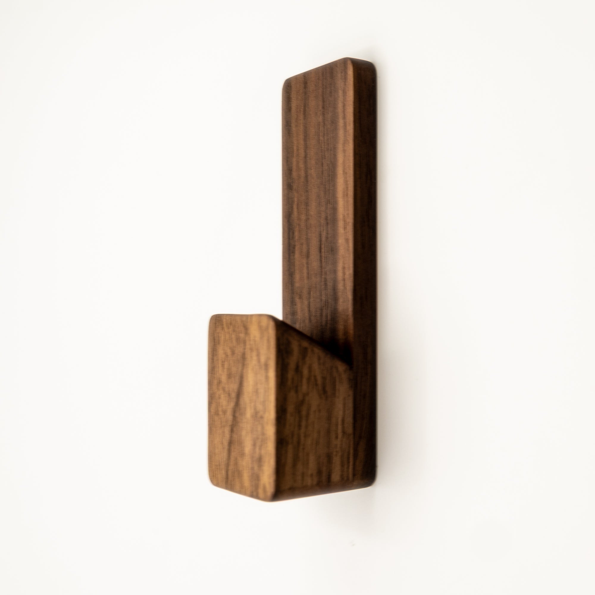 Wooden wall hook on a white background