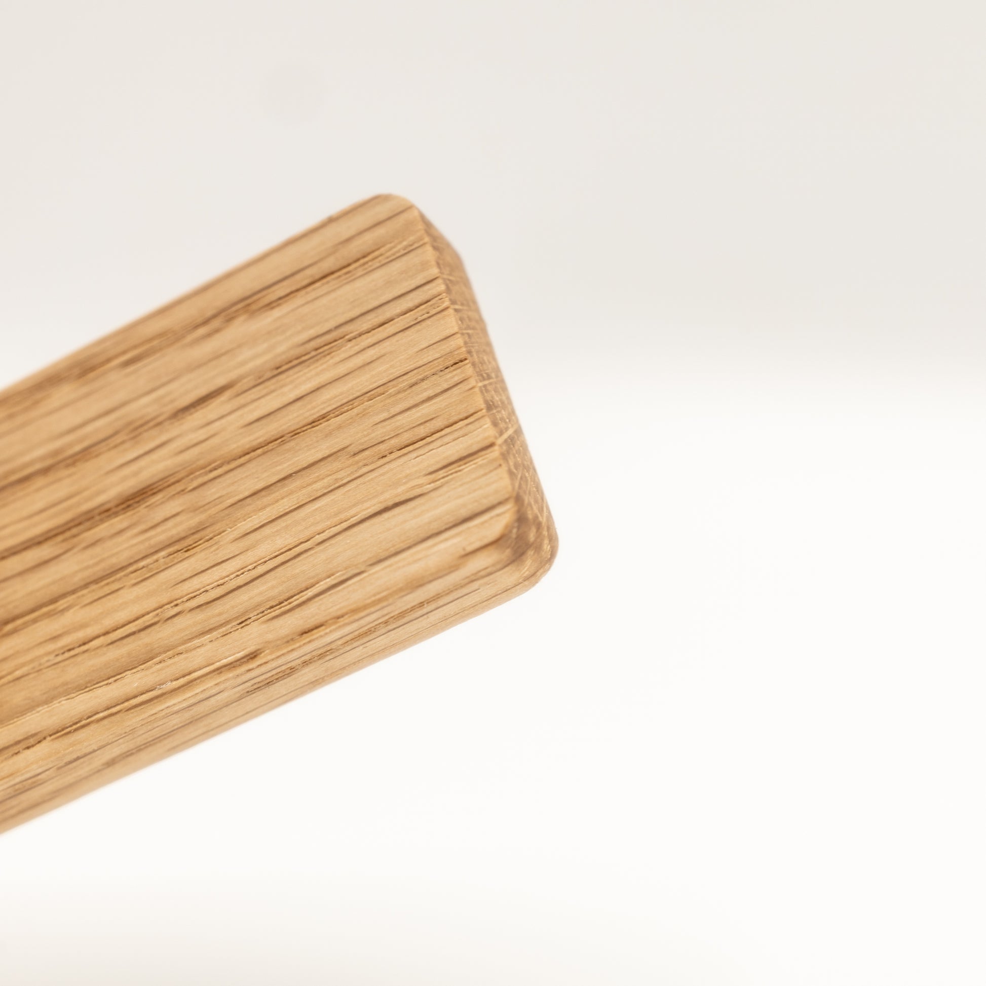 Close-up of natural oak grain on handmade wooden adhesive hook