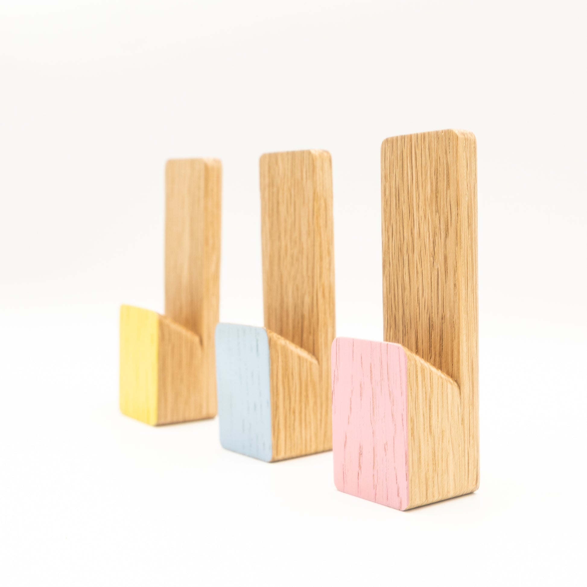 Set of four wooden bookends with colorful bases on a white background