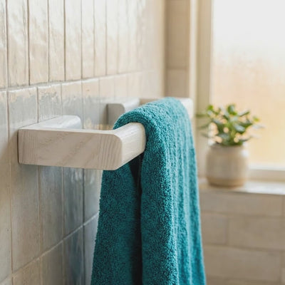 white towel rack on restroom tiles