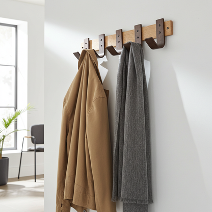 Wooden wall hook with two coats hanging on it in a room.